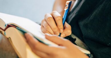 shallow focus photo of person writing